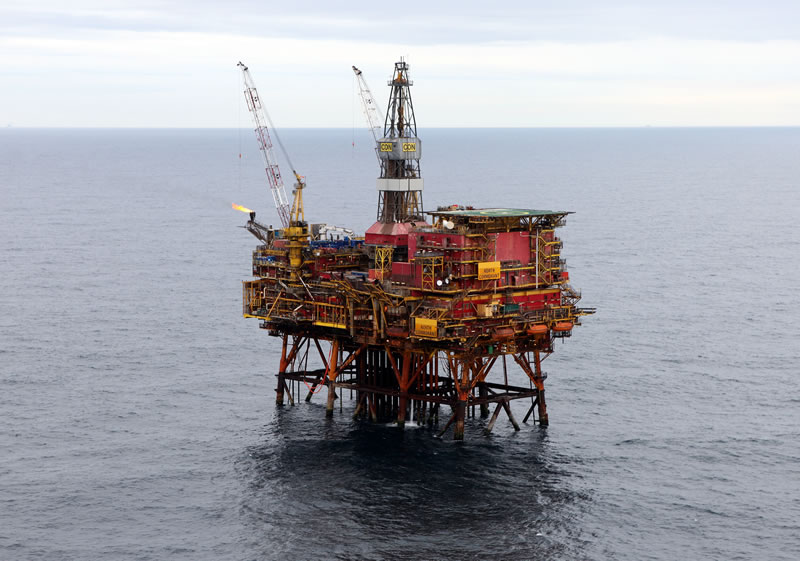 Aerial view of an offshore oil platform with equipment and a helipad