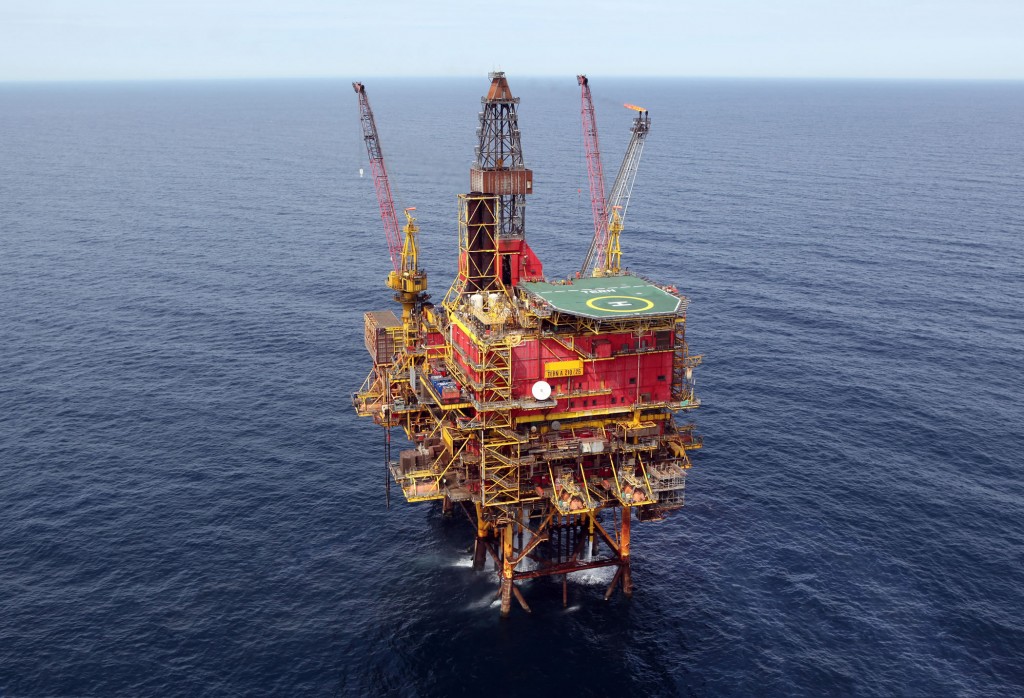Aerial view of an offshore oil platform with equipment and a helipad